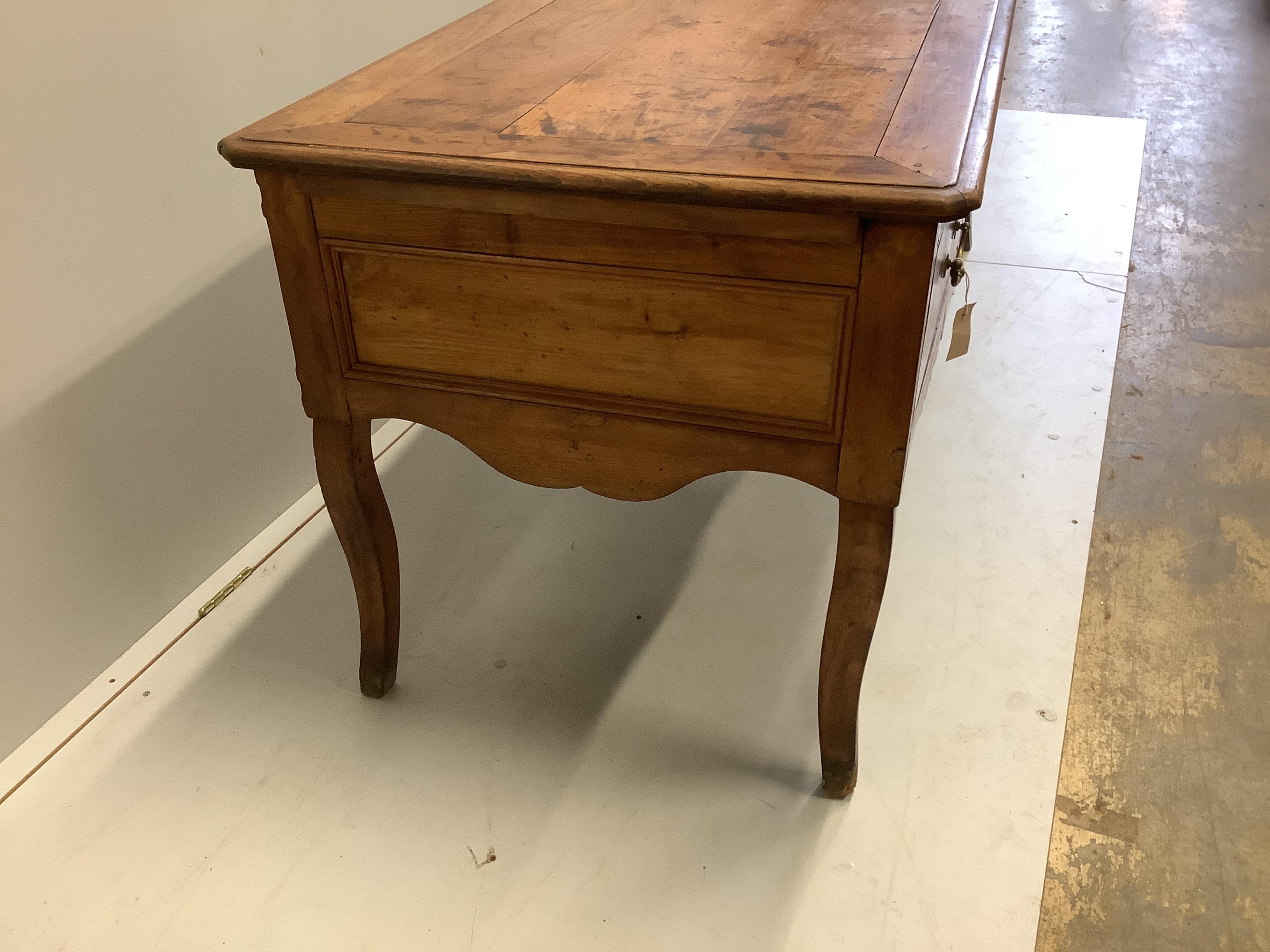 A late 18th century French Provincial fruitwood kneehole table, width 178cm, depth 70cm, height 74cm